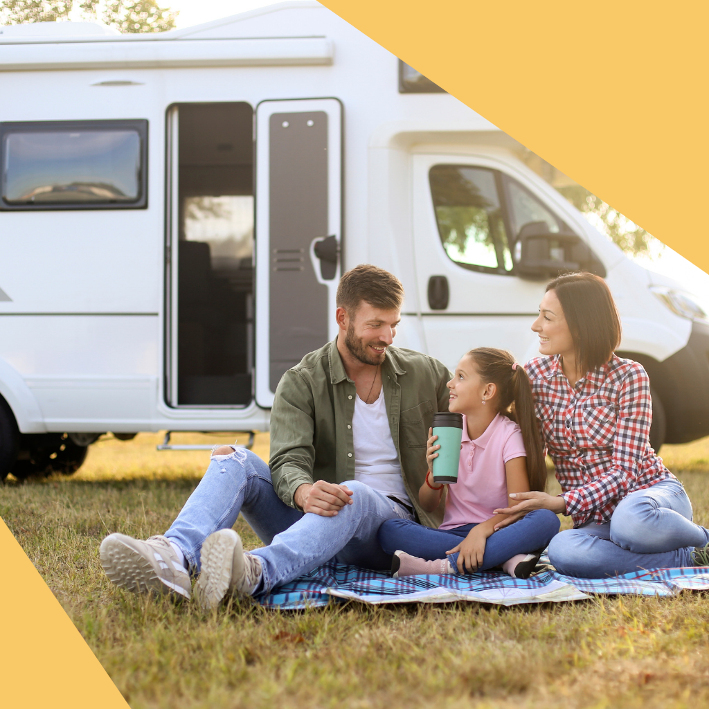 family sitting on the ground with car park